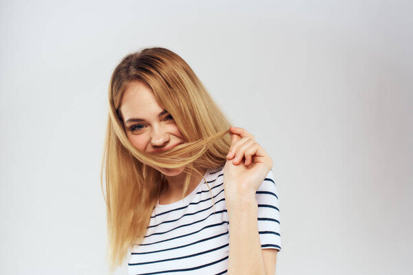 emotional woman in striped t-shirt gesture with hands lifestyle light background