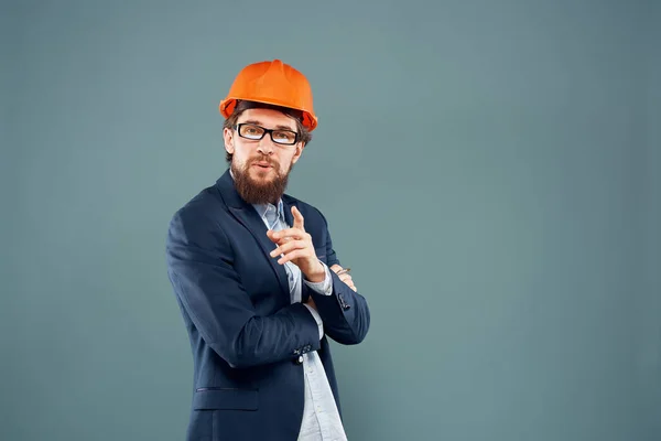Engineer in orange paint job industry professional construction blue background