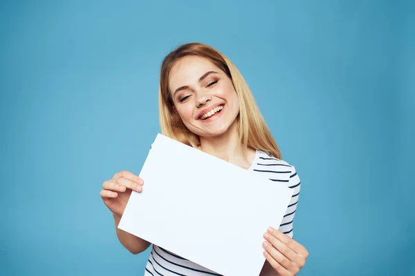 Mulher emocional segurando uma folha de papel em suas mãos estilo de vida close-up fundo azul Espaço Copiar — Fotografia de Stock