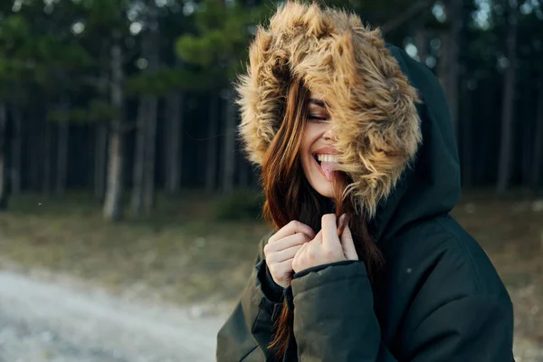 Cheerful woman in hooded jacket travel adventure lifestyle walk — Stock Photo, Image