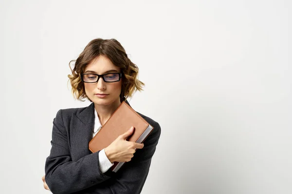 Donna al lavoro con libro in mano luce sfondo classico vestito occhiali testa — Foto Stock