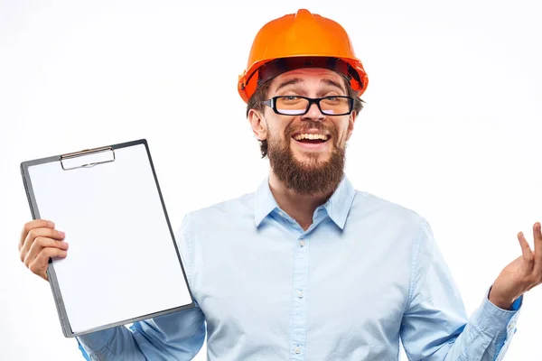 Cheerful workers orange paint documents construction industry light background