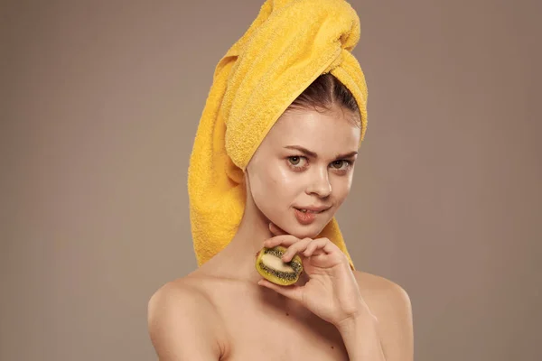 Cheerful woman with bare shoulders towel on her head clean skin health kiwi freshness — Stock Photo, Image