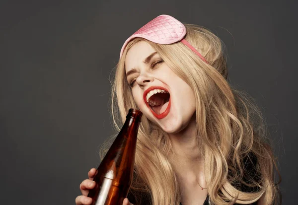 Femme ivre avec une bouteille de bière maquillage lumineux masque rose blonde pour le sommeil — Photo