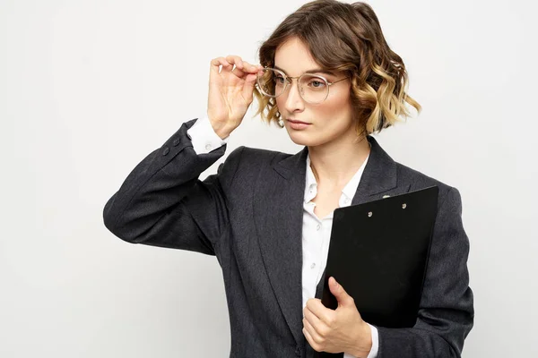 Woman in business suit finances work documents glasses hairstyle