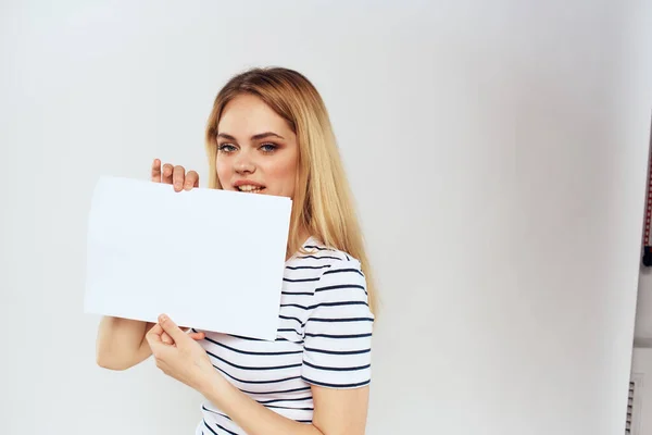 Woman holding a sheet of paper in her hands lifestyle striped t-shirt cropped view Copy Space — Stock Photo, Image