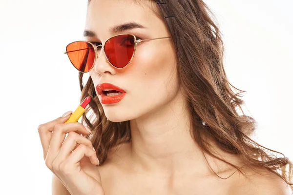 Fashionable brunette in sunglasses with makeup lipstick model