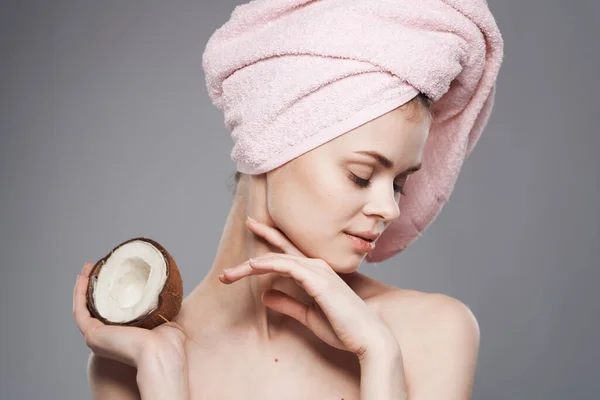 Cheerful woman with pink towel on her head coconut spa treatments clean skin health — Stock Photo, Image