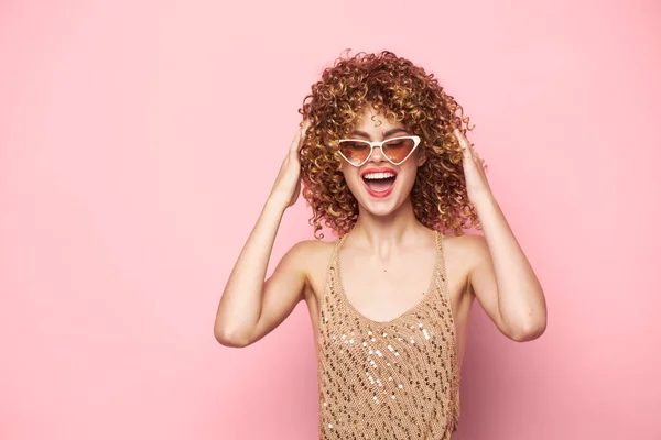 Красивая женщина Веселые модные очки вьющиеся волосы розовый фон — стоковое фото