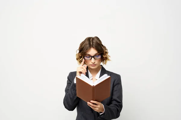 Zakelijke vrouw in een klassiek pak met een notitieboekje in haar hand en bril op haar gezicht Copy Space — Stockfoto