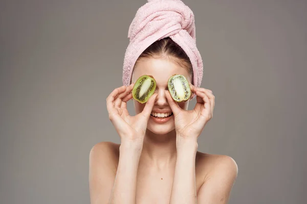 Cheerful woman naked shoulders kiwi vitamins cosmetics skin care