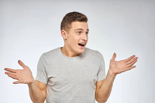 Handsome man in gray t-shirt cropped view of emotion Studio Model — Stock Photo, Image