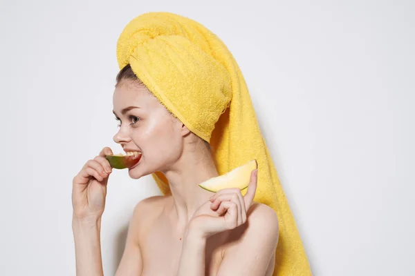 Woman with mango in hands bared shoulders towel on head exotic fruits bared shoulders — Stock Photo, Image