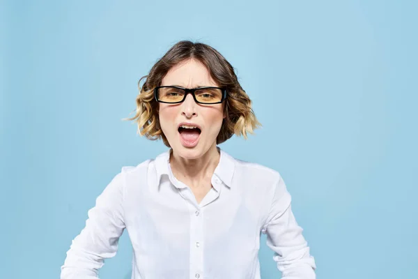 Üzleti nő egy könnyű póló egy kék háttér gesztusok kezével érzelmek modell munka — Stock Fotó