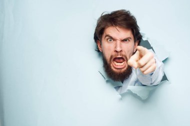 Öfkeli adam elleriyle el kol hareketi yapar. Duygularını tatmin etmez. Çalışma ofisi.