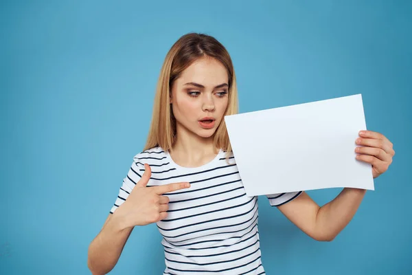 Эмоциональная женщина держит в руках лист бумаги образ жизни крупным планом синий фон — стоковое фото