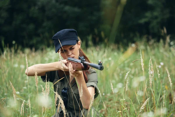 Mujer en la naturaleza Arma en mano caza vista hojas verdes — Foto de Stock