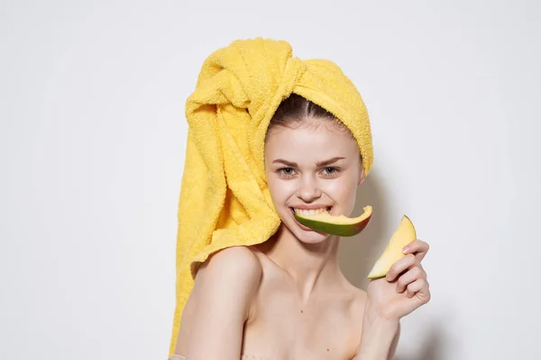 Woman with bare shoulders yellow towel on head mango exotic vitamins fruits — Stock Photo, Image