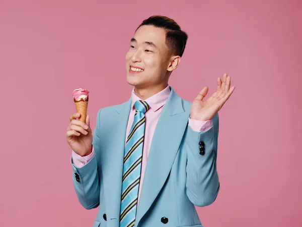 handsome man elegance blue suit ice cream in hands joy emotions isolated background