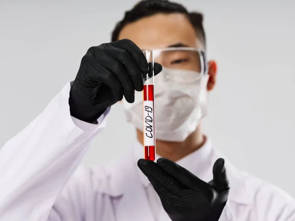 Asian male black gloves research covid-19 lab tests — стокове фото