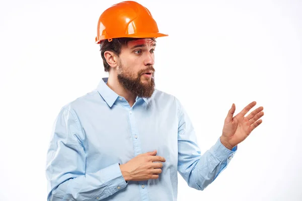 Ein Mann mit orangefarbenem Helm arbeitete im hellen Hintergrund — Stockfoto