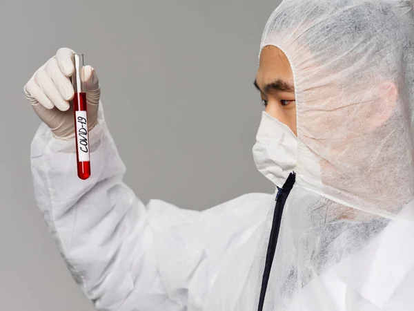 Asian male protective clothing analysis testing diagnostics close-up — Stock Photo, Image