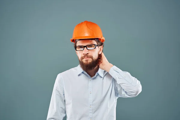 Человек в оранжевой каске рубашка обрезанный вид синий фон строительные работы — стоковое фото