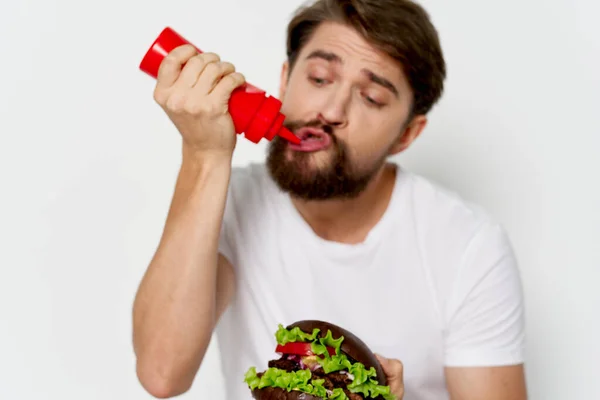 Man with hamburger sauce in the hands of fast food — Stock Photo, Image