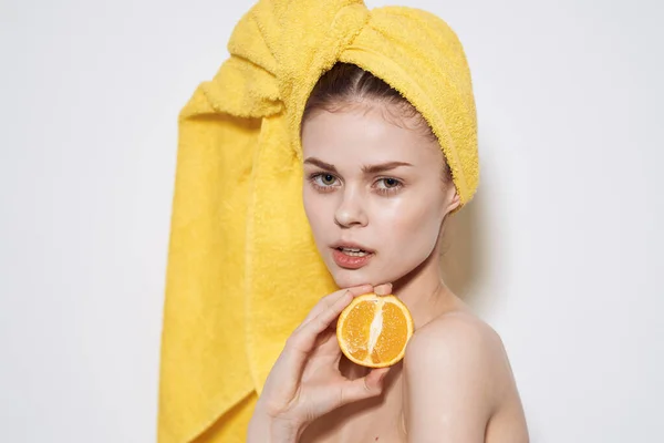 Pretty woman orange in hands naked shoulders natural cosmetics cropped views — Stock Photo, Image