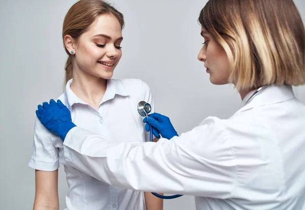 Female doctor in blue gloves injection syringe communication patient — Stock Photo, Image