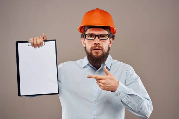 Man in orange hard hat professional safety manual documents work — Stock Photo, Image