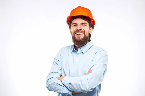 Cheerful man orange hard hat work industry professional lifestyle light background — Stock Photo, Image