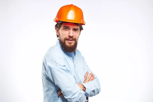 Cheerful man orange hard hat work industry professional lifestyle light background — Stock Photo, Image