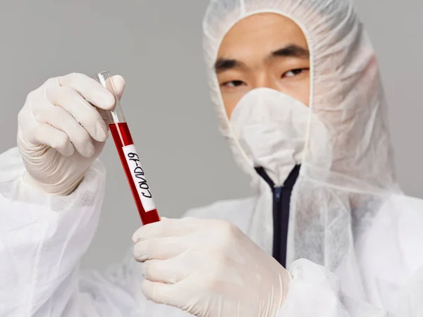 Male laboratory assistant protective mask analyzes diagnostics treatment vaccine development close-up