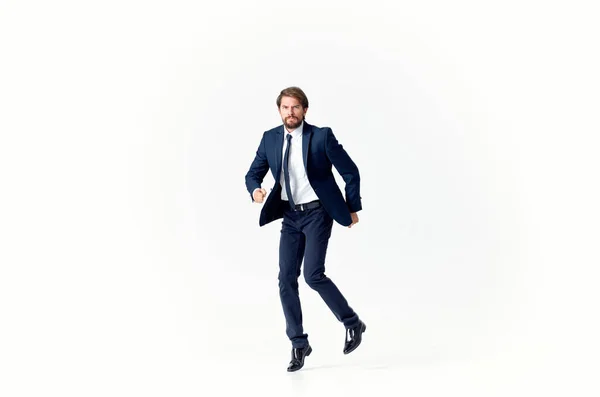 Um homem em um fundo claro caminha e salta para o lado em pleno crescimento de finanças de negócios — Fotografia de Stock