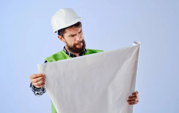 Engineer building uniform white hard hat drawing in hands working project at home