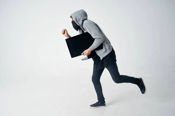 masked man with hood steals monitor technician hacker marking