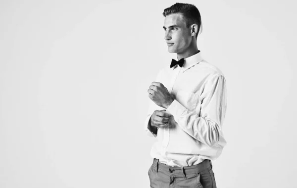 Side view of a handsome gentleman in a shirt in a bow tie — Stock Photo, Image