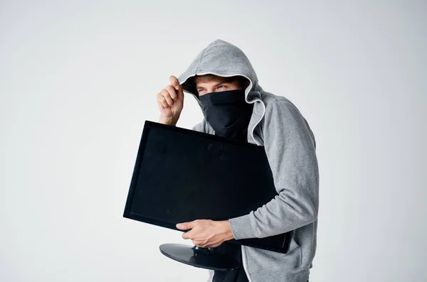 masked man with hood steals monitor technician hacker marking