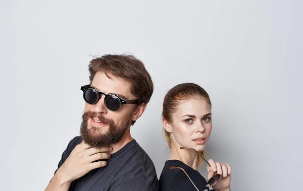 cute man and woman wearing sunglasses black t shirts lifestyle cropped view studio communication