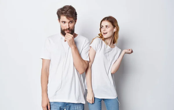 Fröhliche Mann und Frau mit Kopfhörern Musik hören und tanzen auf grauem Hintergrund abgeschnittene Ansicht — Stockfoto