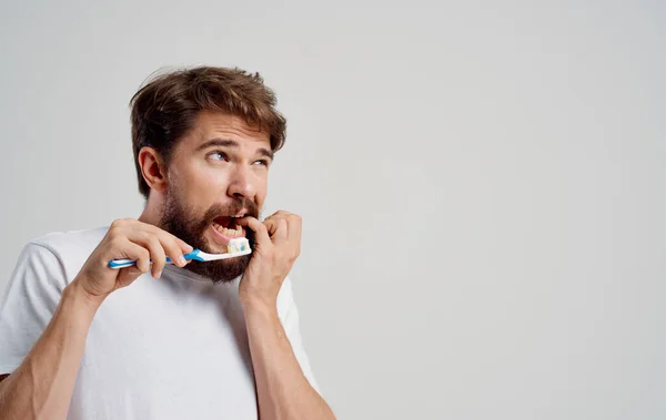 Dolor de muelas hombre con barba fondo claro camiseta modelo cavidad oral cuidado — Foto de Stock