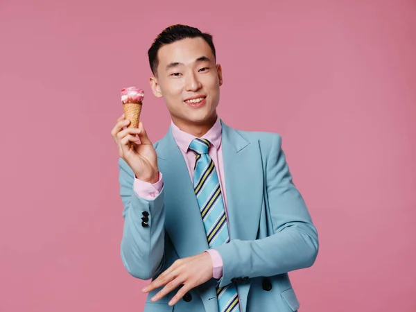 Cheerful man of Asian appearance ice cream enjoyment fun pink background — Stock Photo, Image