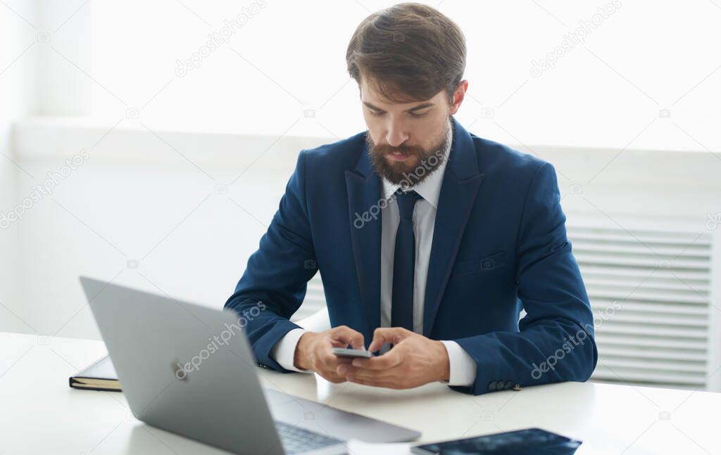 business man in classic suit at the table in the office