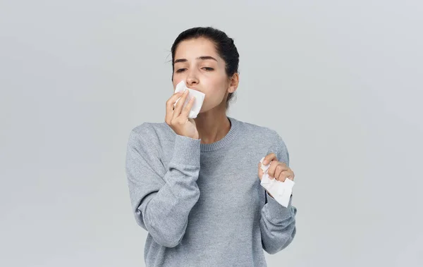Mulher corrimento nariz problemas de saúde camisola cinza guardanapo — Fotografia de Stock
