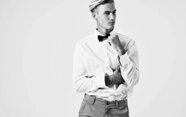 Side view of a handsome gentleman in a shirt in a bow tie — Stock Photo, Image