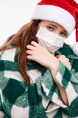 Şirin bir kız. Noel kıyafetleri. Tıbbi maske.