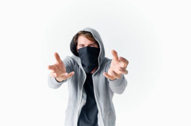 Kapüşonlu maskeli bir adam elleriyle gangsterleri soyuyor.