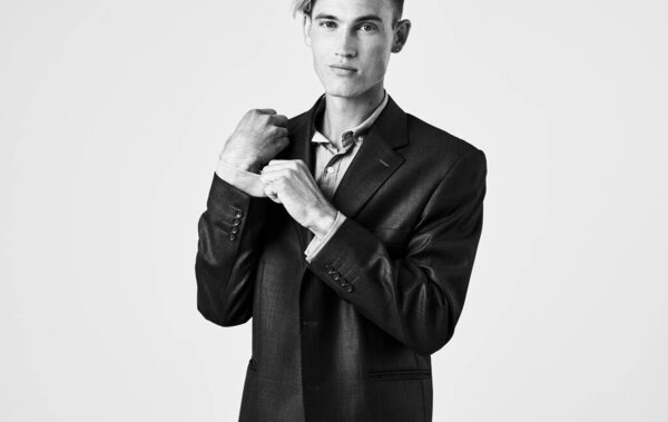 Portrait of a confident man in shirt and jacket black and white photograph cropped view