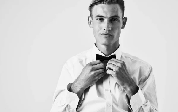 Handsome guy in shirt and bow tie on light background portrait cropped view — Stock Photo, Image